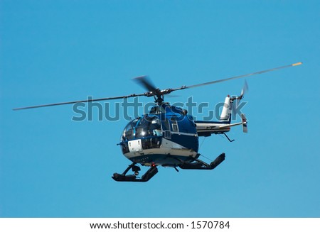 Photo of a helicopter against a blue sky