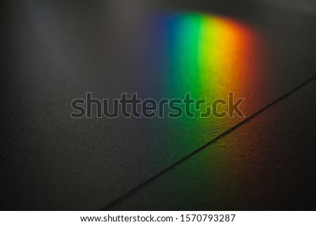 Minimalist composition of small spectrum from glass reflex to texture on floor. Close up macro photo can show how beautiful of rainbow glare spectrum that look science and interesting to learning.