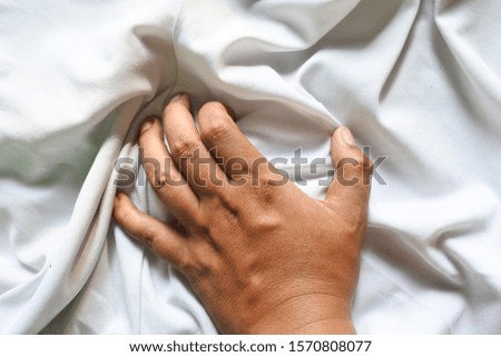 close up hand hold the white sheet cloth