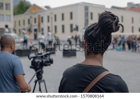 Camera man recording live event in public