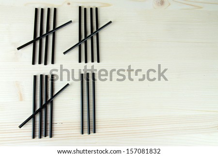 Cocktail tubes - counting days concept on wooden background