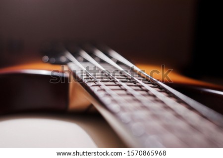 blurred vintage bass guitar closeup