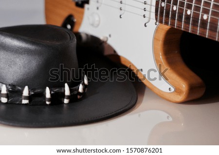 blurred vintage electric guitar and cowboy hat 