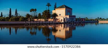 Menara Pavilion and Gardens reflected on the lake at sunshine. Marrakech, Morocco. 