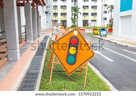 Traffic light caution signboard warning oncoming vehicles