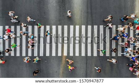 Aerial. Pedestrians on a zebra crosswalk. Top view. Royalty-Free Stock Photo #1570947877