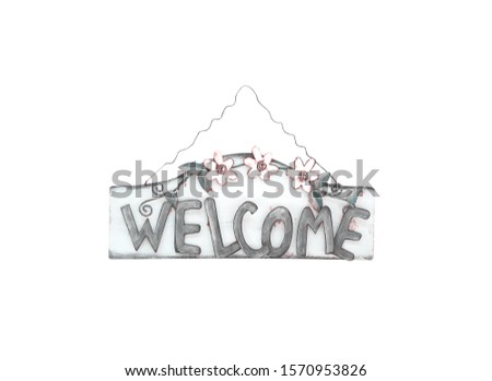 Vintage rusty metal sign with welcome text and flowers pattern hanging on old steel isolated on white background , clipping path
