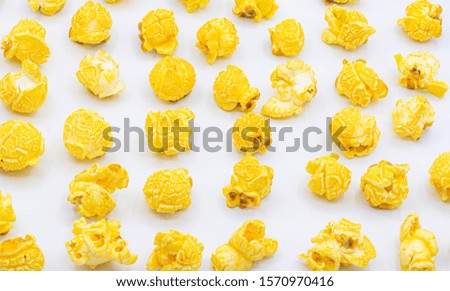 Delicious popcorn with caramel in bowl on
white color background top view