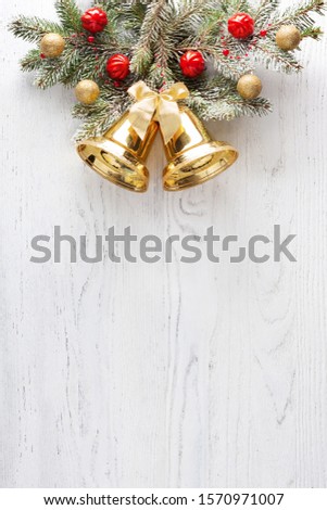 Fir branch with Christmas decorations on white wooden shabby background with copy space for text.