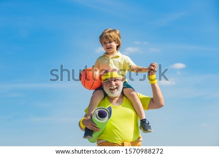 Grandpa and grandson spotting. Father and child training together. I love sport. Active family enjoy sport and fitness. Happy loving family