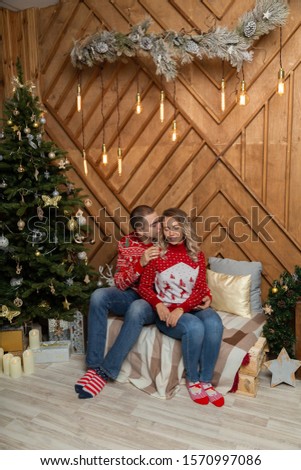 Beautiful happy couple in love in the Christmas decor for Christmas night. Happy Merry Christmas 2020.