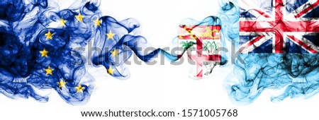 Eu, European Union vs Fiji smoky mystic flags placed side by side. Thick colored silky abstract smoke flags combination