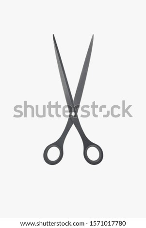 A pair of black scissors on a white background Royalty-Free Stock Photo #1571017780