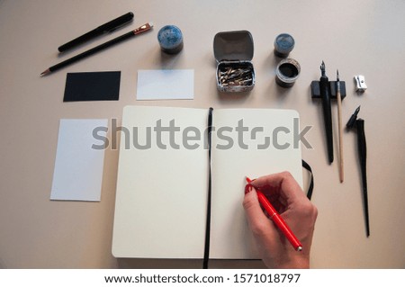 Opened white empty notebook and business card mockup. Drawing and writing instruments. Handwriting. Calligraphy 
 flat lay, top view, copy space.