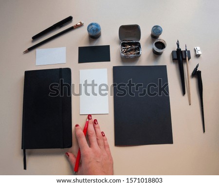 Business card and black notebook mockup. Drawing and writing instruments. Handwriting. Flat lay, top view, copy space.