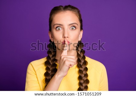 Closeup photo of amazing lady long braids holding finger lips afraid friend will tell handsome guy her secret wear casual yellow jumper isolated purple color background