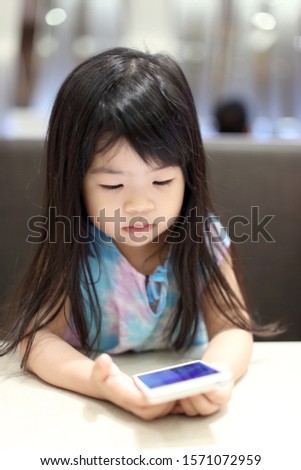 The Asian girl using smart phone.