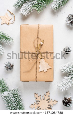 Zero west and eco friendly christmas concept flat lay with gift, branches and toy on white background, copy space, top view