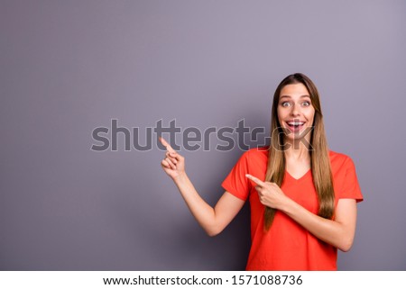 Portrait of impressed girl promoter look incredible promotion adverts point index finger scream wow omg wear modern youth clothing isolated over grey color background