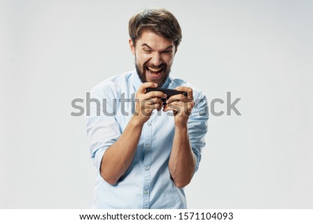 Emotional man with a phone in his hands providing internet device services