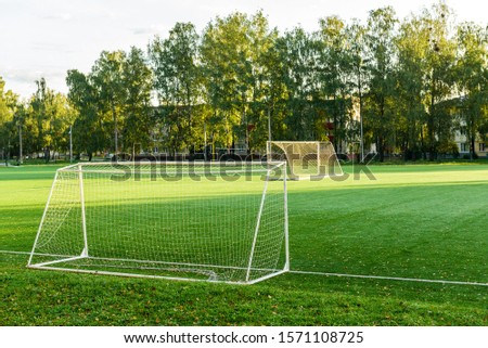 Outdoors mini football court with artificial turf. Football goal grass of a city stadium.