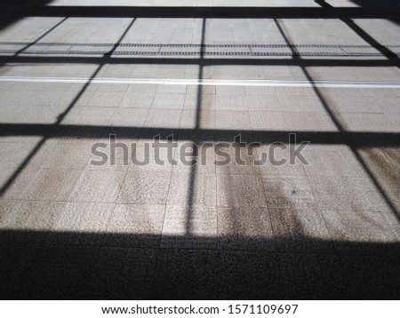 Grid pattern shadow on the floor