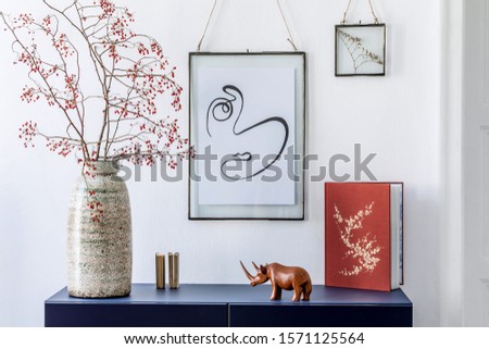 Stylish scandinavian interior design with mock up picture frames, navy blue commode, flowers in vase, book and elegant accessories. Modern home decor. Living room. Template Ready to use. 
