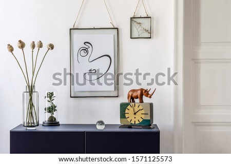 Stylish scandinavian living room with mock up photo frame, navy blue commode, retro clock, vase with flowers and elegant accessories. Modern home decor. Interior design. Template Ready to use. 