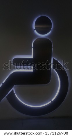 The wheelchair symbol in the front of the bathroom ... is made of stainless steel and has the reflections of the rear lights to look outstanding and beautiful.