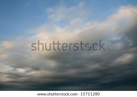 stormy weather at summer, dark clouds over blue sky