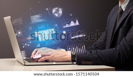 Businessman working on laptop with BUSINESS MODEL inscription, new business concept Royalty-Free Stock Photo #1571140504