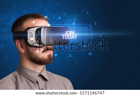 Businessman looking through Virtual Reality glasses with JOIN TODAY inscription, social networking concept