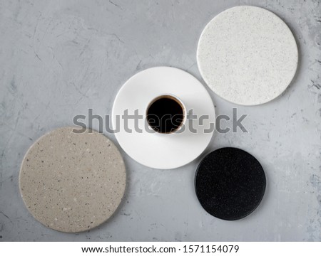 Round coasters made of artificial stone tabletop on a white background. Food stand. Coffee cup top view. Royalty-Free Stock Photo #1571154079