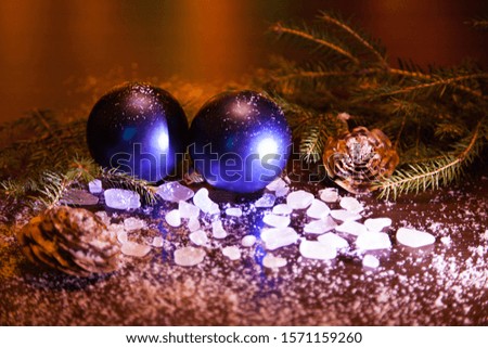 Beautiful Christmas background, blue balls, cones, ice, spruce branches. Everything is fabulously covered with snow. Concept, holiday symbol, Christmas, New year, fairy tale.
