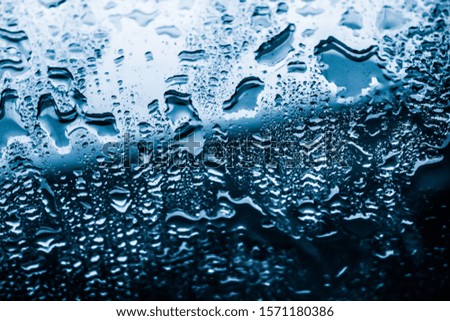 Liquid, wet and zen concept - Water texture abstract background, aqua drops on blue glass as science macro element, rainy weather and nature surface art backdrop for environmental brand design