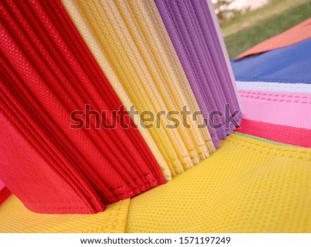 Rainbow Colors with Non Woven Fabric Bags on Green Grass