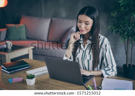 Photo of cheerful positive representative of business people browsing through laptop collecting information about successful startups