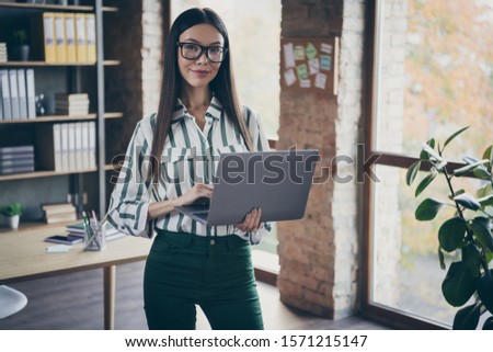 Photo of cheerful joyful girlfriend working as recruiter for a famous corporation listening to employee attentively noting his information down to laptop in green pants