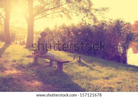 Vintage photo of woman sitting on bench with her dog