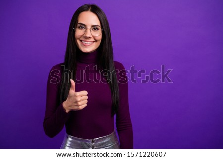 Photo of fun cheerful positive cute woman working as consultant recommending you to pruchase goods isolated showing thumb up vibrant color purple background