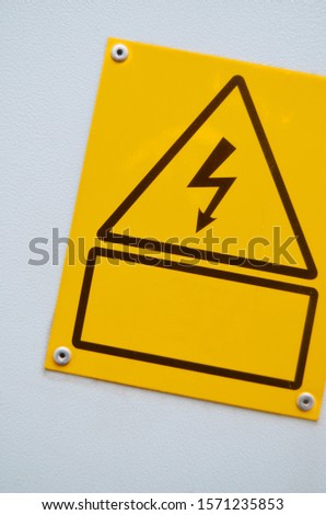 High energy sign on a white metal background.
