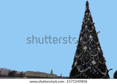 Christmas tree. Garland and star decorations. New Years is soon. Vacation. Artificial fir. City spruce. Thorny branches. Festive mood. Waiting for the magic. View of the Neva River and Kuntskamera. 