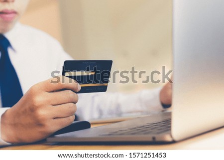 Businessman use computers and Hands holding credit card, Online shopping Concept
