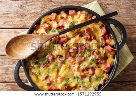 Strata bread casserole with ham, onions, cheese and eggs close-up in a pan on the table. Horizontal top view from above
 Royalty-Free Stock Photo #1571292955