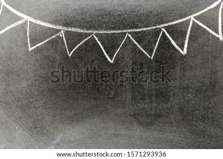 White chalk hand drawing in party flag shape on blackboard background with copy space for decoration or add text