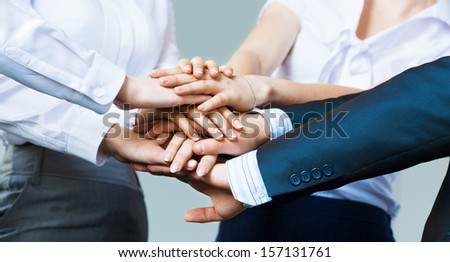 concept of teamwork. business people joined hands