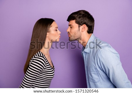 Profile photo of two people couple guy lady standing opposite eyes closed romance moment kissing affectionate wear stylish casual outfit isolated pastel purple color background Royalty-Free Stock Photo #1571320546
