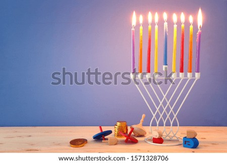 religion image of jewish holiday Hanukkah background with menorah (traditional candelabra) and spinning top