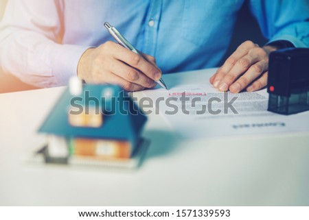 man sign approved family house mortgage contract