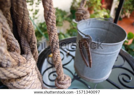 rope with recipient over water well